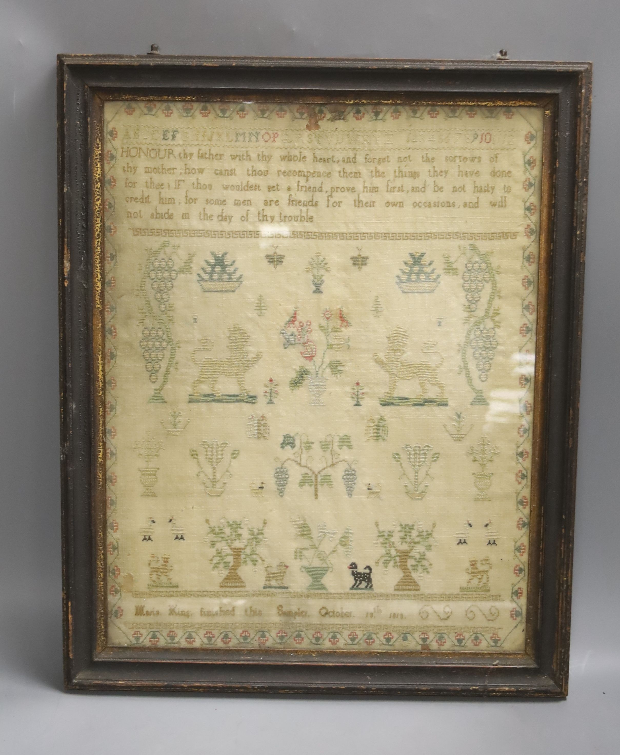 An 1813 sampler, by Maria King, framed. 39x30cm